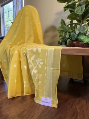 yellow cotton jamdani saree with white floral and butta motifs