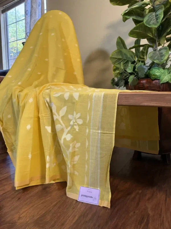 yellow cotton jamdani saree with white floral and butta motifs