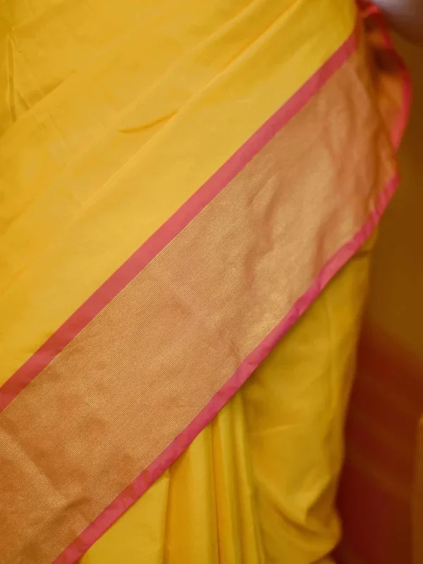 Yellow color with pink border kanjivaram work on Satin Silk Saree